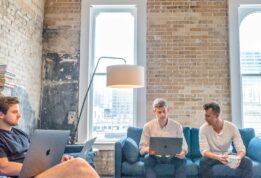 three men using MacBooks